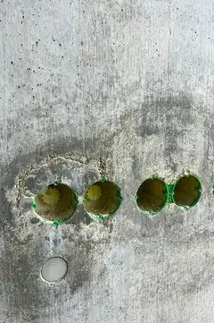 Vier Elektrodosen in einer Reihe, um die Aussparungen ist der Beton ausgeblutet und rau, darunter eine weiße Abdeckscheibe