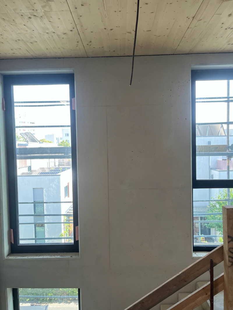 Nachher: Ortbetonwand an der Fensterseite unter der Holzdecke im Treppenhauskopf, Stand Rohbauphase, Poren erhalten